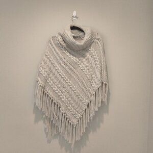 Reserved cable knit turtleneck poncho with fringe